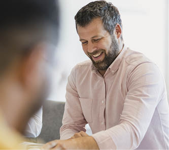 Candid portrait of confident man in his 40s at conference table, business meeting, professional occupation, relaxation, enjoyment